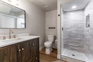 Full bathroom for basement bedroom 4 and 5 featuring vanity, a shower stall, and LVP flooring