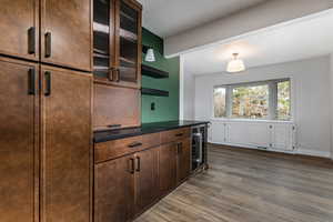Kitchen with granite countertops, extractor fan, recessed lighting, stainless steel dishwasher, and a dining nook.