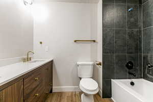 Bathroom for bedrooms 2 and 3 featuring vanity, wood finished floors, and bathtub / shower combination