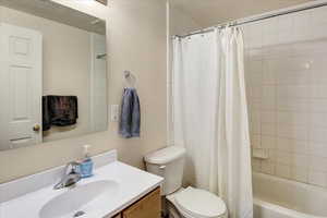 Full bathroom with vanity and shower / bathtub combination with curtain