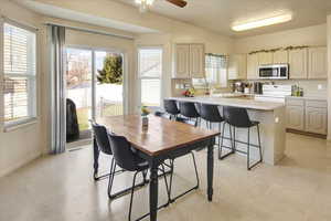 Dining room with ceiling fan and light floors