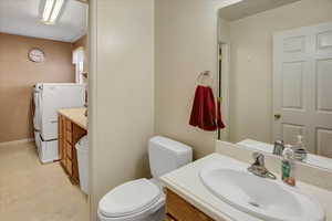 Bathroom featuring vanity and independent washer and dryer