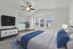 Bedroom featuring lofted ceiling, ceiling fan, and carpet floors
