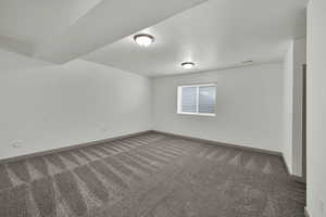 Spare room with a textured ceiling and carpet floors