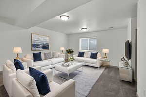 Carpeted living room featuring baseboards