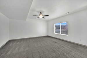 Unfurnished room with light colored carpet, a textured ceiling, and a ceiling fan