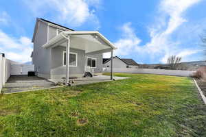 Back of house featuring a patio, a fenced backyard, and a gate