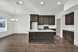 Kitchen featuring dark brown cabinetry, black range with electric cooktop, a chandelier, recessed lighting, and decorative light fixtures