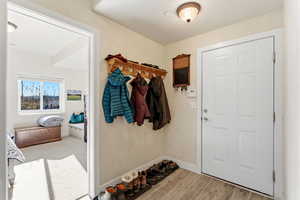 Mudroom with wood tiled floors and baseboards