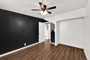 Unfurnished bedroom featuring dark wood-style flooring, ceiling fan, and a closet