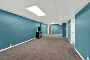 Carpeted empty room featuring baseboards