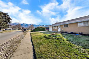 View of grassy yard with a mountain view