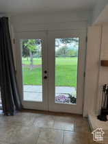 Doorway to outside with french doors and stone tile flooring