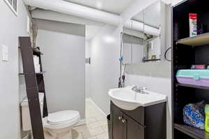 Half bathroom featuring vanity and light tile patterned floors
