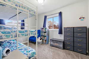 Bedroom featuring light colored carpet and baseboards
