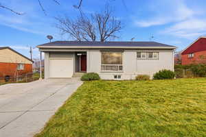 Ranch-style house featuring concrete driveway, a garage, brick siding, and roof with shingles