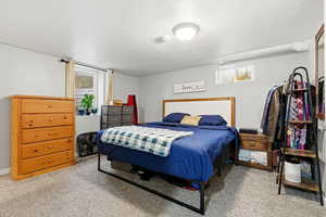 Carpeted bedroom featuring a textured ceiling