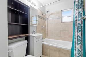 Bathroom with vanity and tiled shower / bath combo