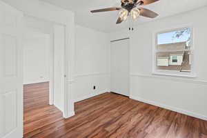 bedroom 1 featuring wood finished floors and a ceiling fan