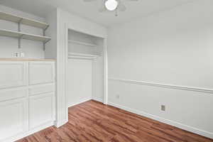 bedroom 2 with dark wood-type flooring, a ceiling fan, and a closet