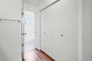 Hallway featuring dark wood-style floors