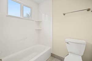 Full bath with tub / shower combination and tile patterned floors