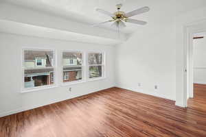 Primary bedroom featuring wood finished floors and a ceiling fan
