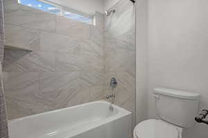 Bathroom with shower / bathtub combination and toilet
