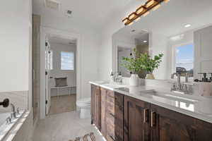 Master Bathroom featuring double vanity, a garden tub, light marble finish floors, and a shower stall
