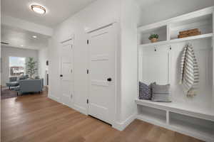 Mudroom with light wood-type flooring and recessed lighting