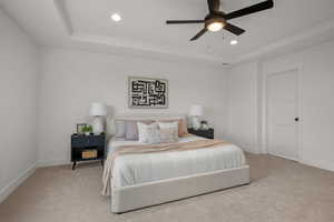 Master Bedroom with a raised ceiling, carpet floors, ceiling fan, and recessed lighting