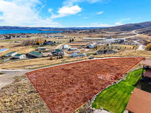 Aerial overview of property's location featuring property parcel outlined and a mountain backdrop