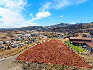 Aerial view of property's location featuring property parcel outlined and a mountainous background