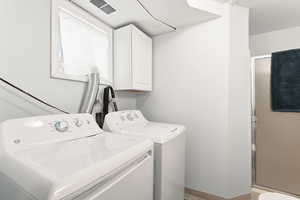 Washroom with independent washer and dryer and baseboards