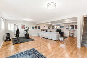 Exercise area featuring light wood-style flooring and baseboards
