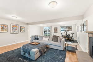 Living area featuring a tile fireplace and light wood-style flooring