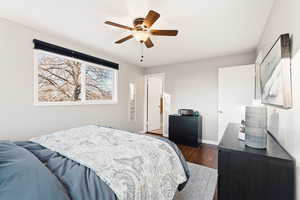 Bedroom featuring ceiling fan and dark wood-style flooring