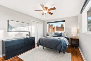 Bedroom featuring a closet, ceiling fan, and wood finished floors