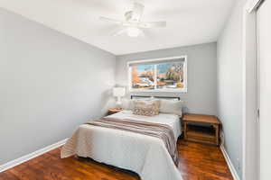 Bedroom with dark wood-type flooring and ceiling fan