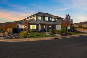 View of front of home featuring stone siding, a tile roof, and stucco siding