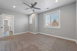 Spare room with healthy amount of natural light, recessed lighting, light carpet, and ceiling fan