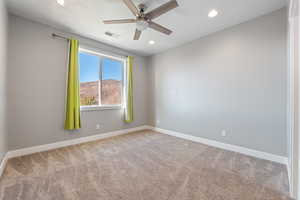 Empty room featuring light colored carpet, a ceiling fan, and recessed lighting