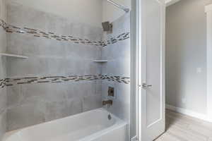 Full bathroom with  shower combination and wood finished floors