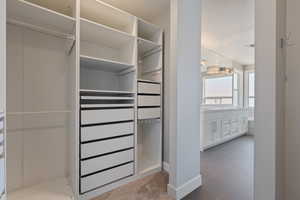 Spacious closet with dark tile patterned flooring