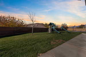 Fenced backyard with a playground