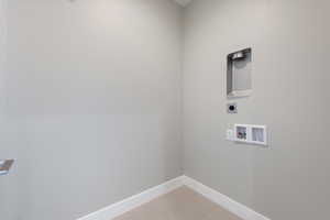 Laundry area with light tile patterned floors, electric dryer hookup, and hookup for a washing machine