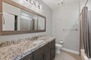 Full bathroom featuring vanity, light tile patterned floors, and shower / bathtub combination with curtain