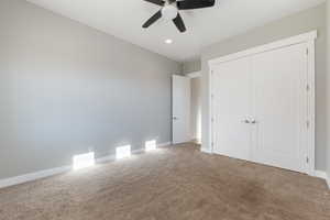 Unfurnished bedroom featuring carpet, a closet, ceiling fan, and recessed lighting