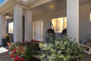 Entrance to property featuring stucco siding and stone siding
