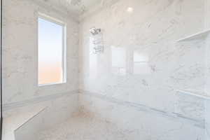 Bathroom featuring a marble finish shower